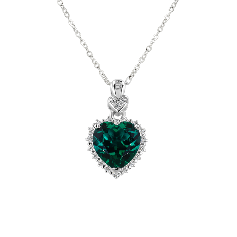 Heart-shaped emerald pendant on a white background